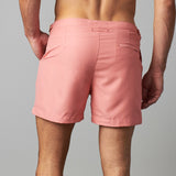 Man wearing tailored swim shorts European style in sand/coral colour