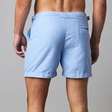 Man wearing tailored swim shorts European style in sky blue